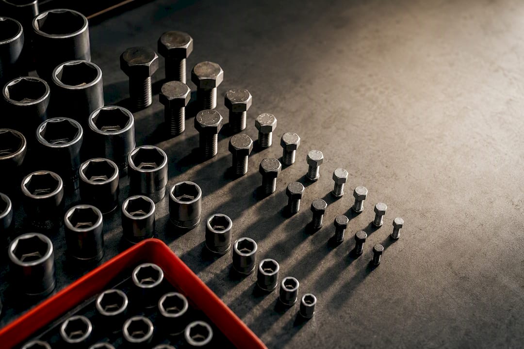 Socket openings and bolt heads on workshop bench