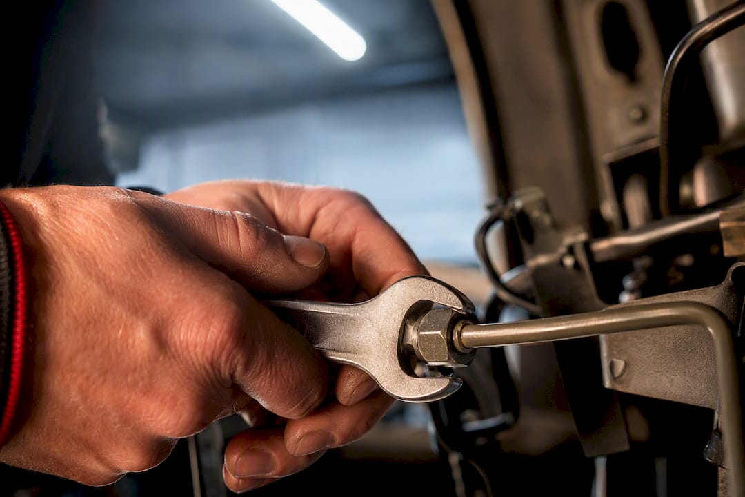 Flare nut wrench gripping a metal fitting