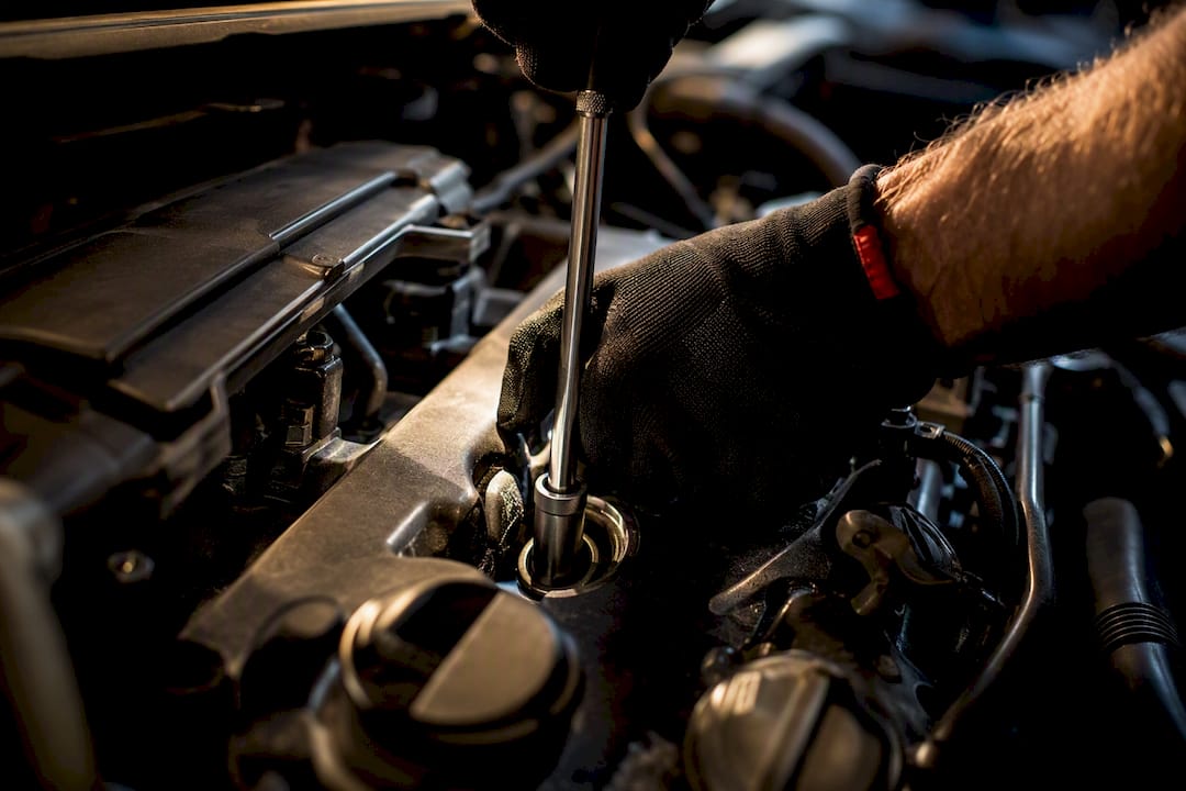 Mechanic using socket on spark plug