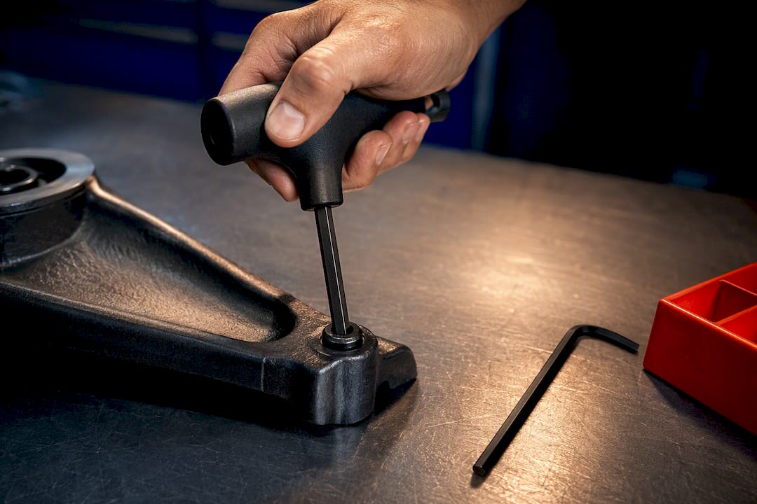 Mechanic comparing T-handle and L-key tools