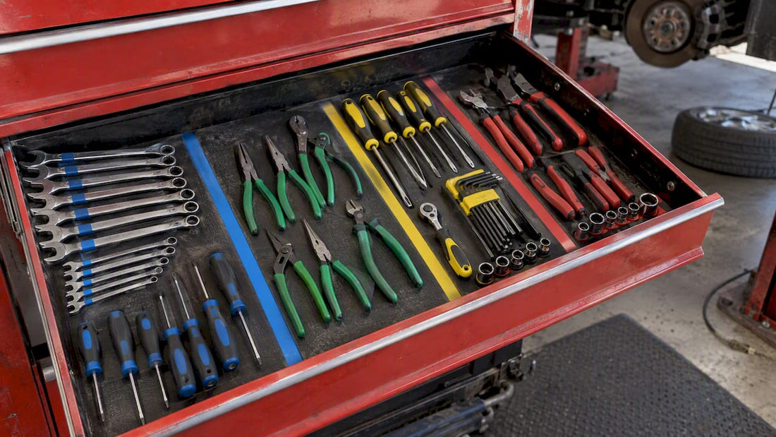 Color-grouped tools arranged in a workshop drawer